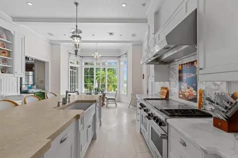 a kitchen with stainless steel appliances granite countertop a sink stove and cabinets