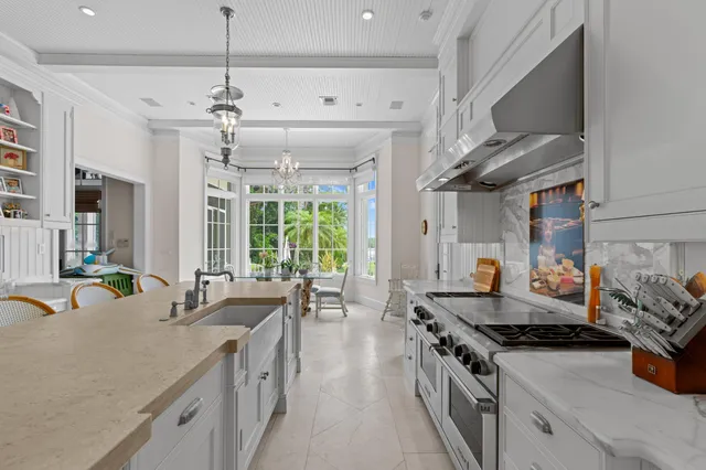 a kitchen with stainless steel appliances granite countertop a sink stove and cabinets