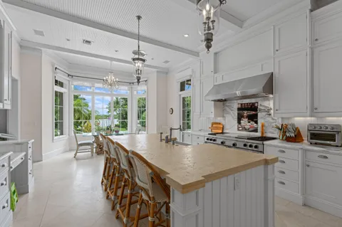 a kitchen with stainless steel appliances granite countertop a stove oven and a refrigerator with white cabinets