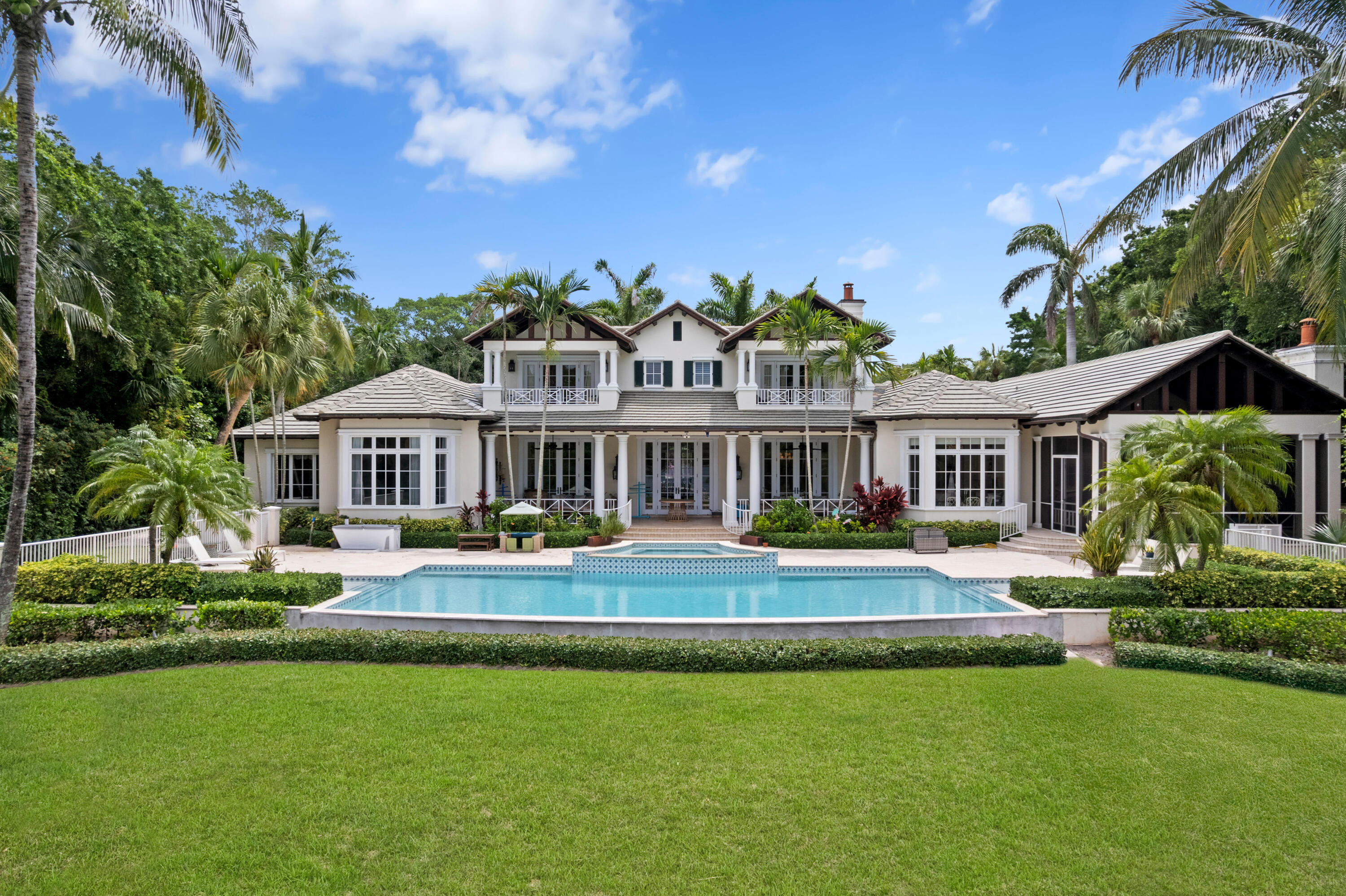 202 Gomez Road Hobe Sound, FL 33455 - Photo 4 of 33 a view of a house with swimming pool and a yard