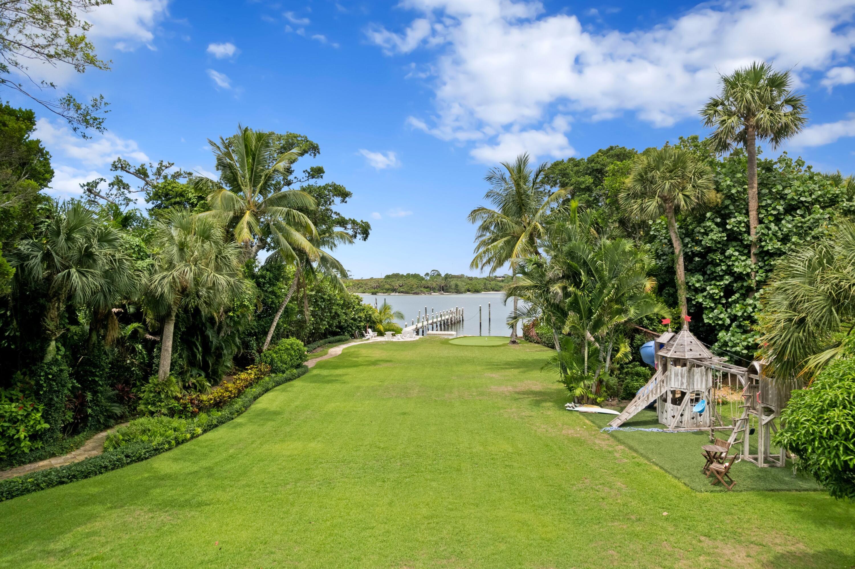 202 Gomez Road Hobe Sound, FL 33455 - Photo 5 of 33 a view of a big yard with plants and a large tree
