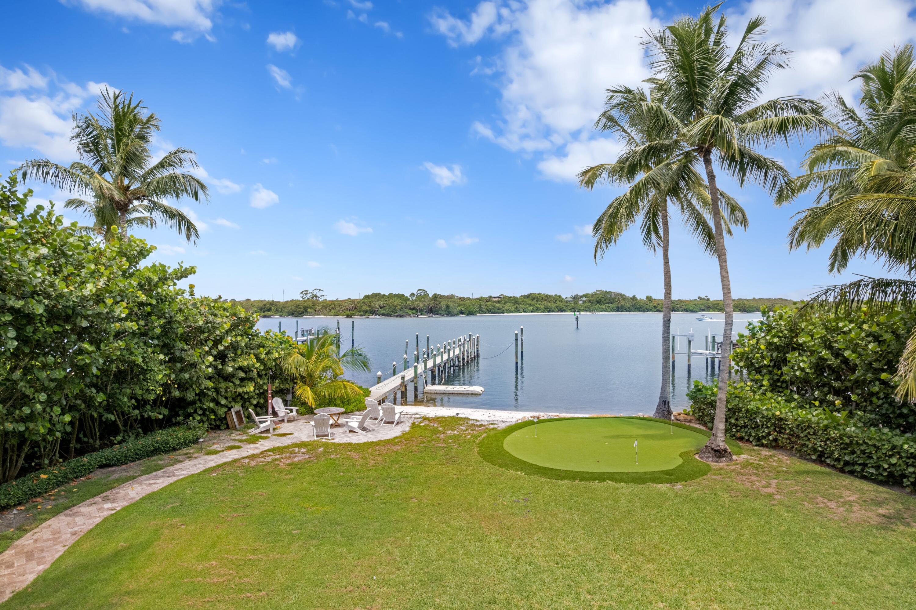 202 Gomez Road Hobe Sound, FL 33455 - Photo 6 of 33 a view of a swimming pool with a table and chairs