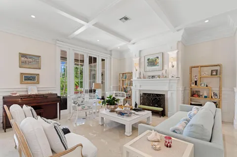 a living room with furniture fireplace and a large window
