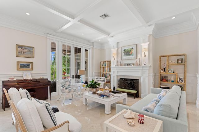 a living room with furniture fireplace and a large window