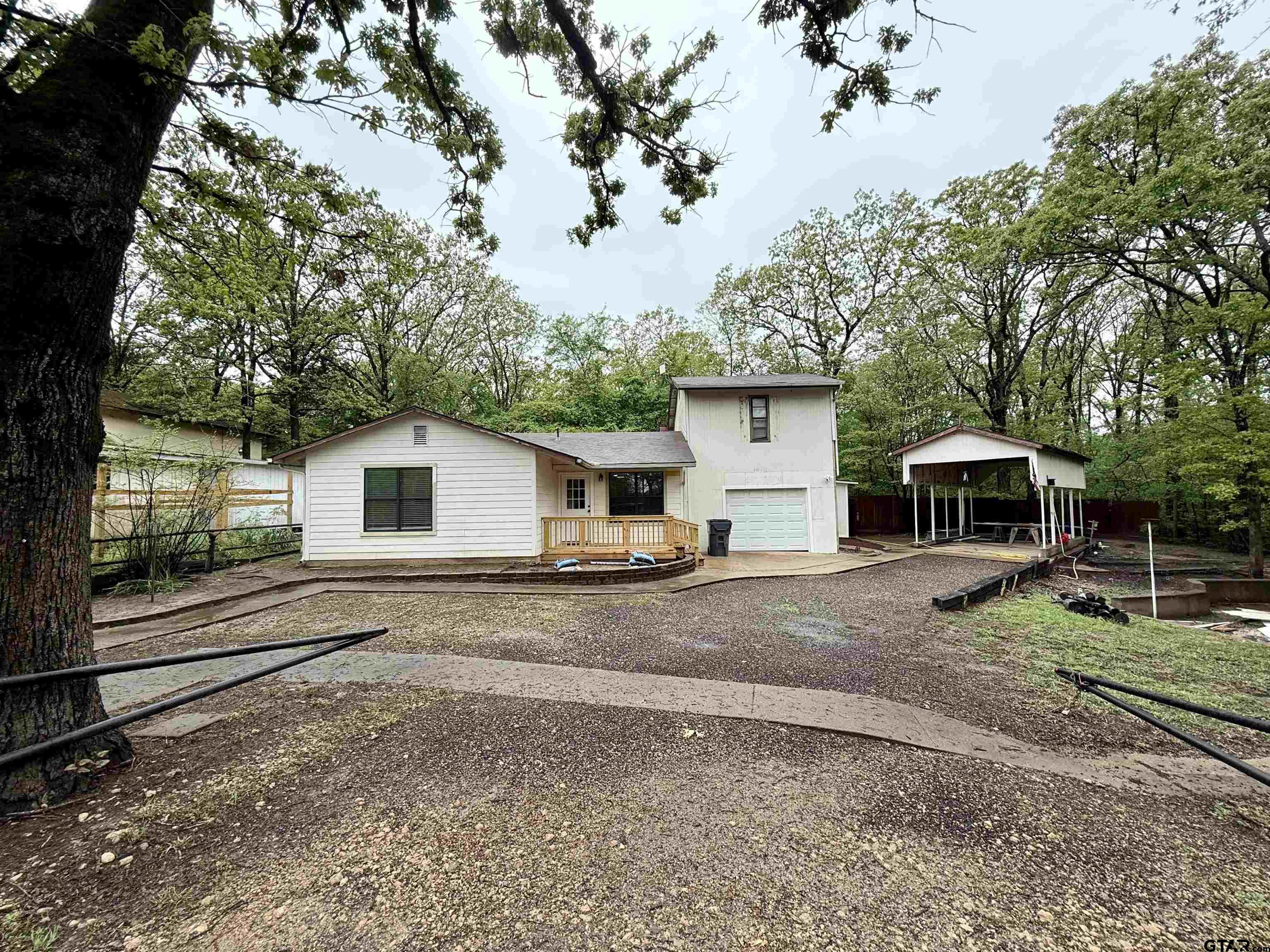 a white house with a large tree in front of it