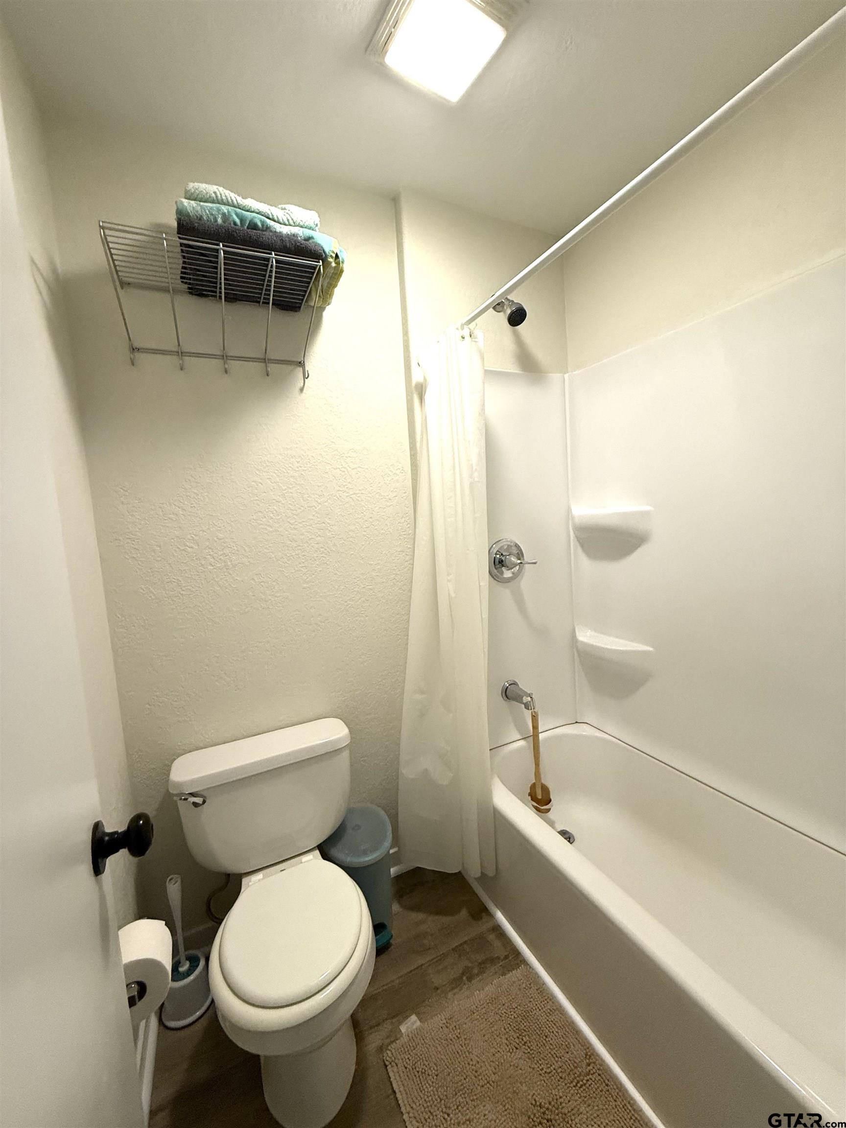 449 Rs Private Road Emory, TX 75440 - Photo 20 of 20 a white toilet sitting next to a bath tub and a shower