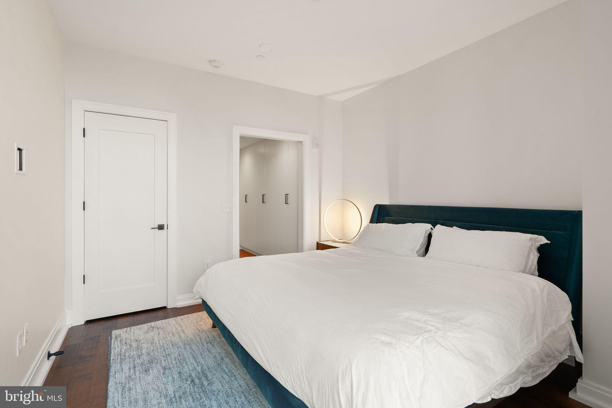 1111 Pennsylvania Ave. Southeast, Unit 304 Washington, DC 20003 - Photo 12 of 42 a bedroom with a bed and a night stand