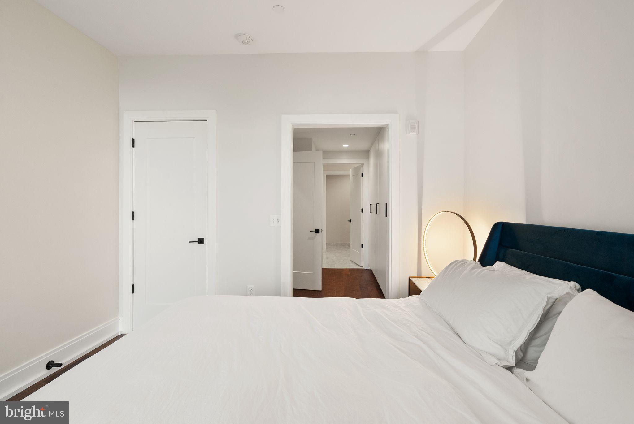 1111 Pennsylvania Ave. Southeast, Unit 304 Washington, DC 20003 - Photo 13 of 42 a bedroom with a bed and a large mirror