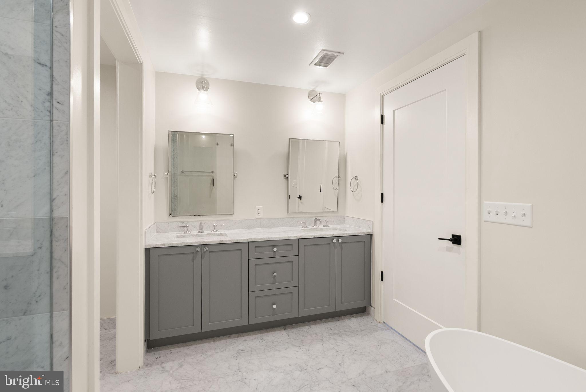1111 Pennsylvania Ave. Southeast, Unit 304 Washington, DC 20003 - Photo 16 of 42 a spacious bathroom with a double vanity sink mirror and a bathtub