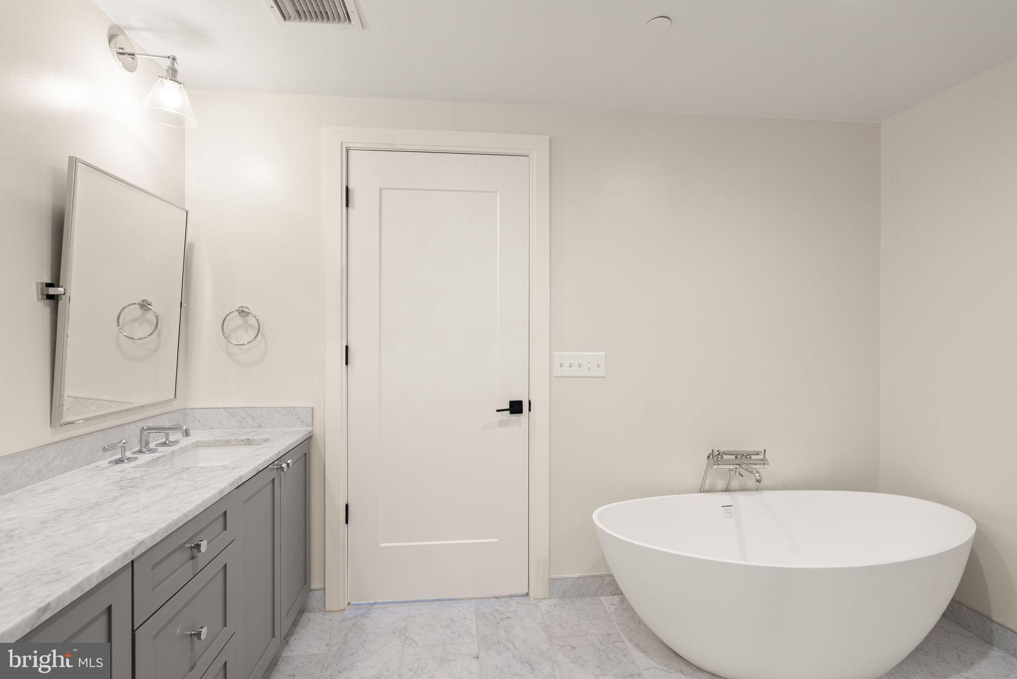 1111 Pennsylvania Ave. Southeast, Unit 304 Washington, DC 20003 - Photo 17 of 42 a spacious bathroom with a bathtub and a sink
