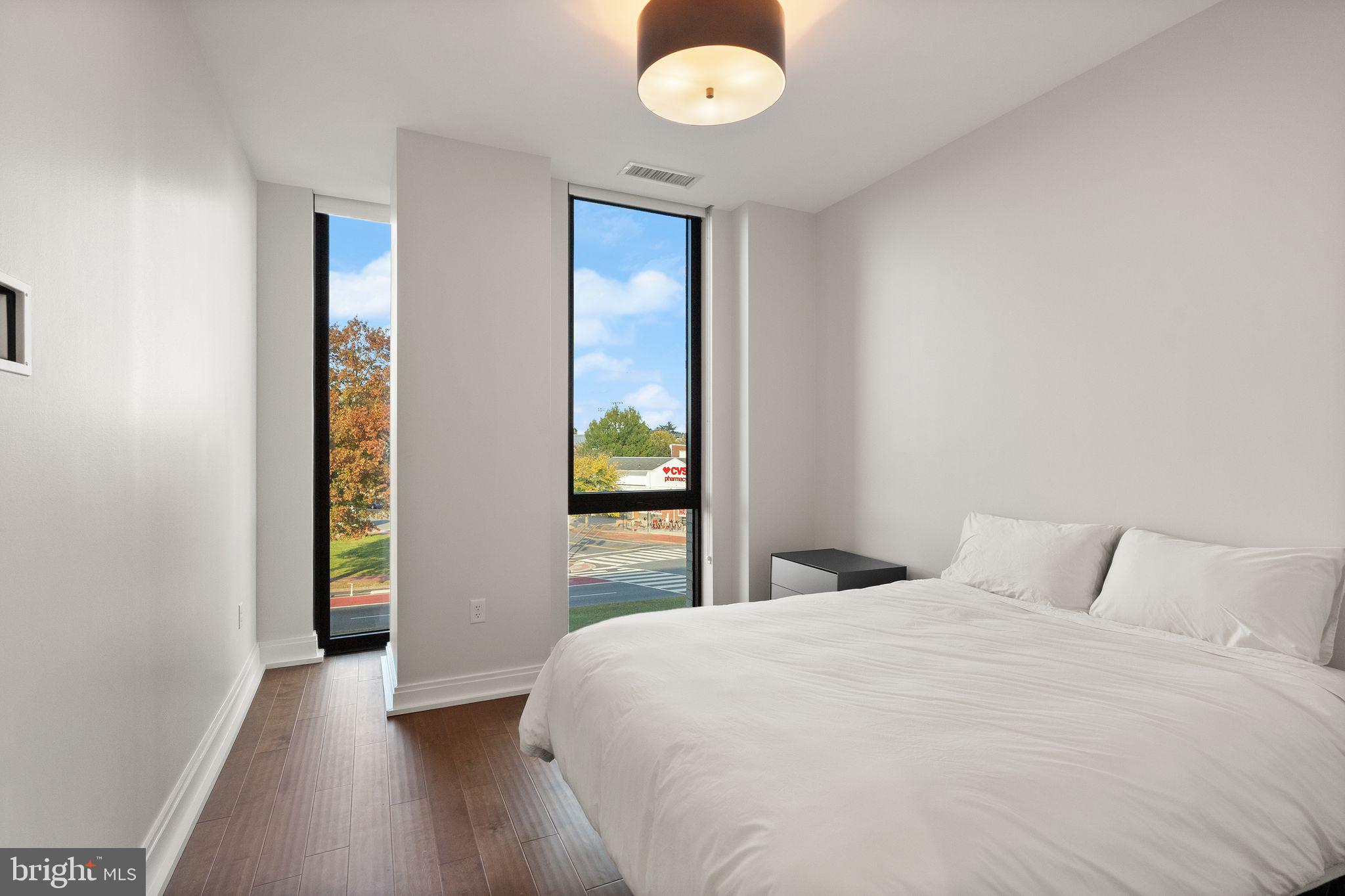 1111 Pennsylvania Ave. Southeast, Unit 304 Washington, DC 20003 - Photo 19 of 42 a bedroom with a bed and a window