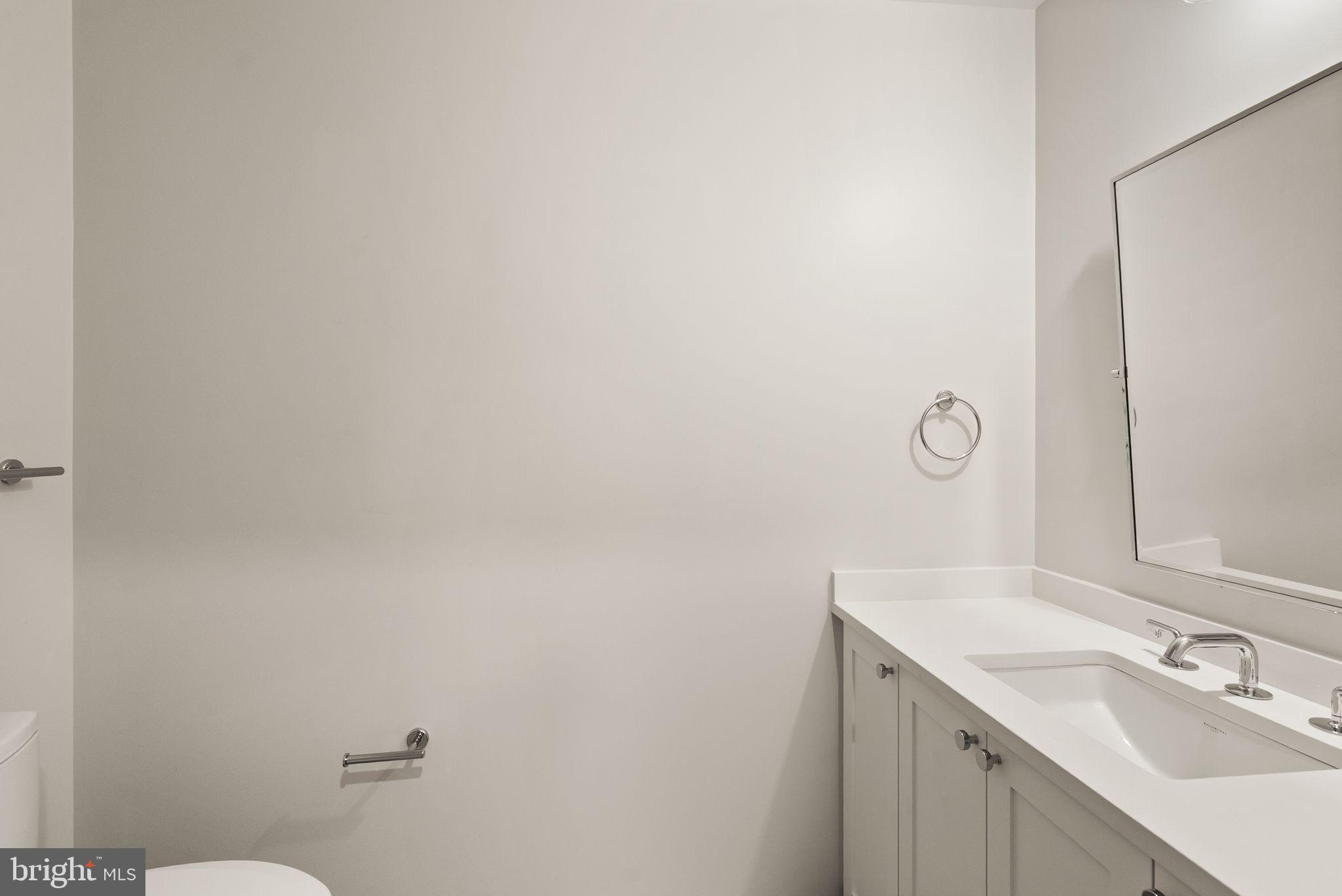 1111 Pennsylvania Ave. Southeast, Unit 304 Washington, DC 20003 - Photo 26 of 42 a bathroom with a sink and mirror