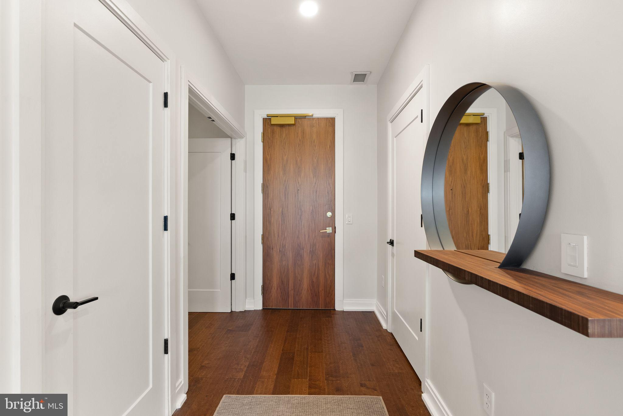 1111 Pennsylvania Ave. Southeast, Unit 304 Washington, DC 20003 - Photo 28 of 42 a view of a hallway with wooden floor and entryway