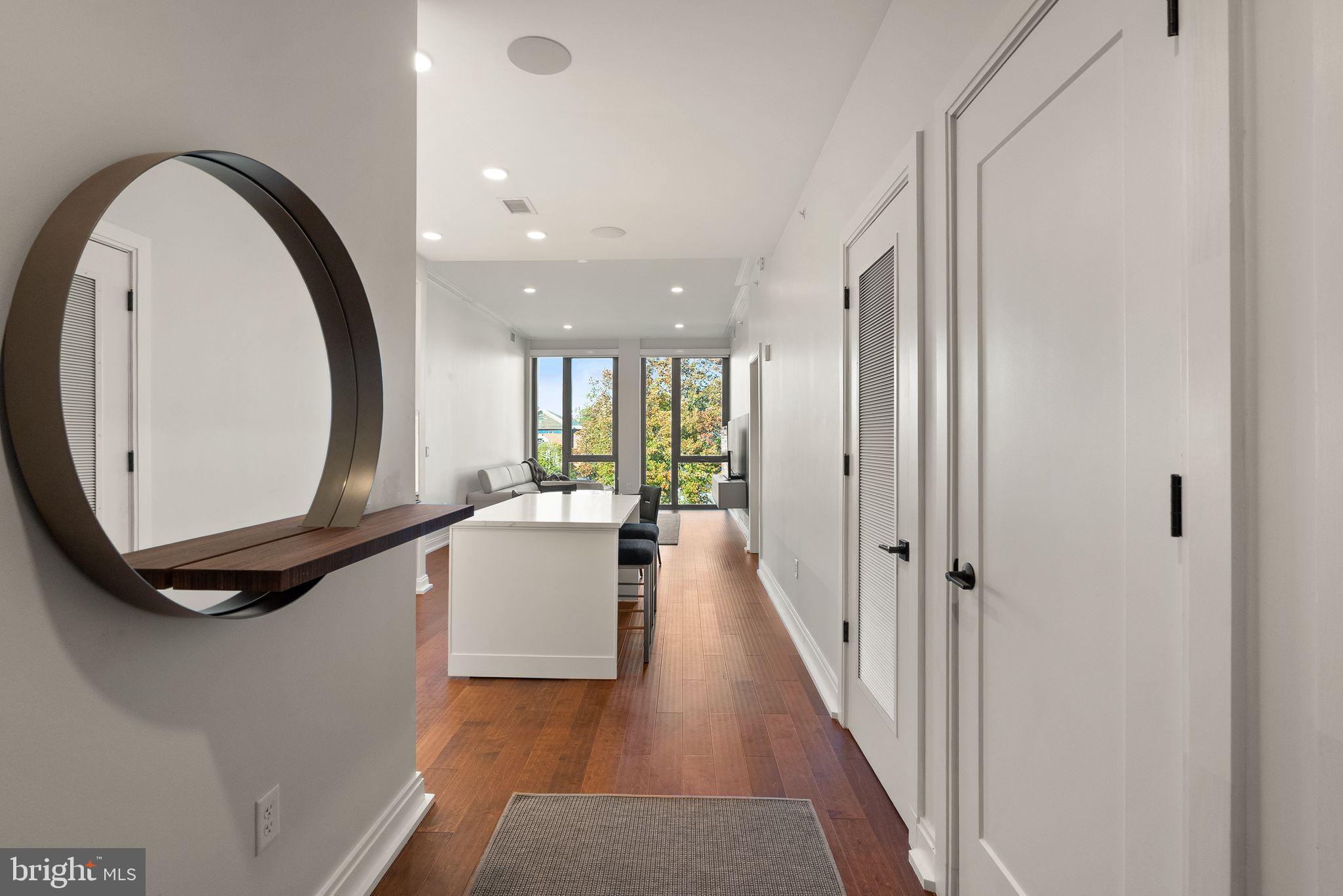 1111 Pennsylvania Ave. Southeast, Unit 304 Washington, DC 20003 - Photo 29 of 42 a view of a hallway with wooden floor and staircase