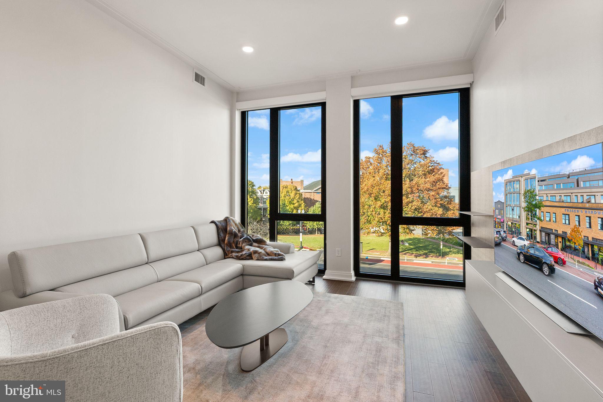 1111 Pennsylvania Ave. Southeast, Unit 304 Washington, DC 20003 - Photo 3 of 42 a living room with furniture and a large window