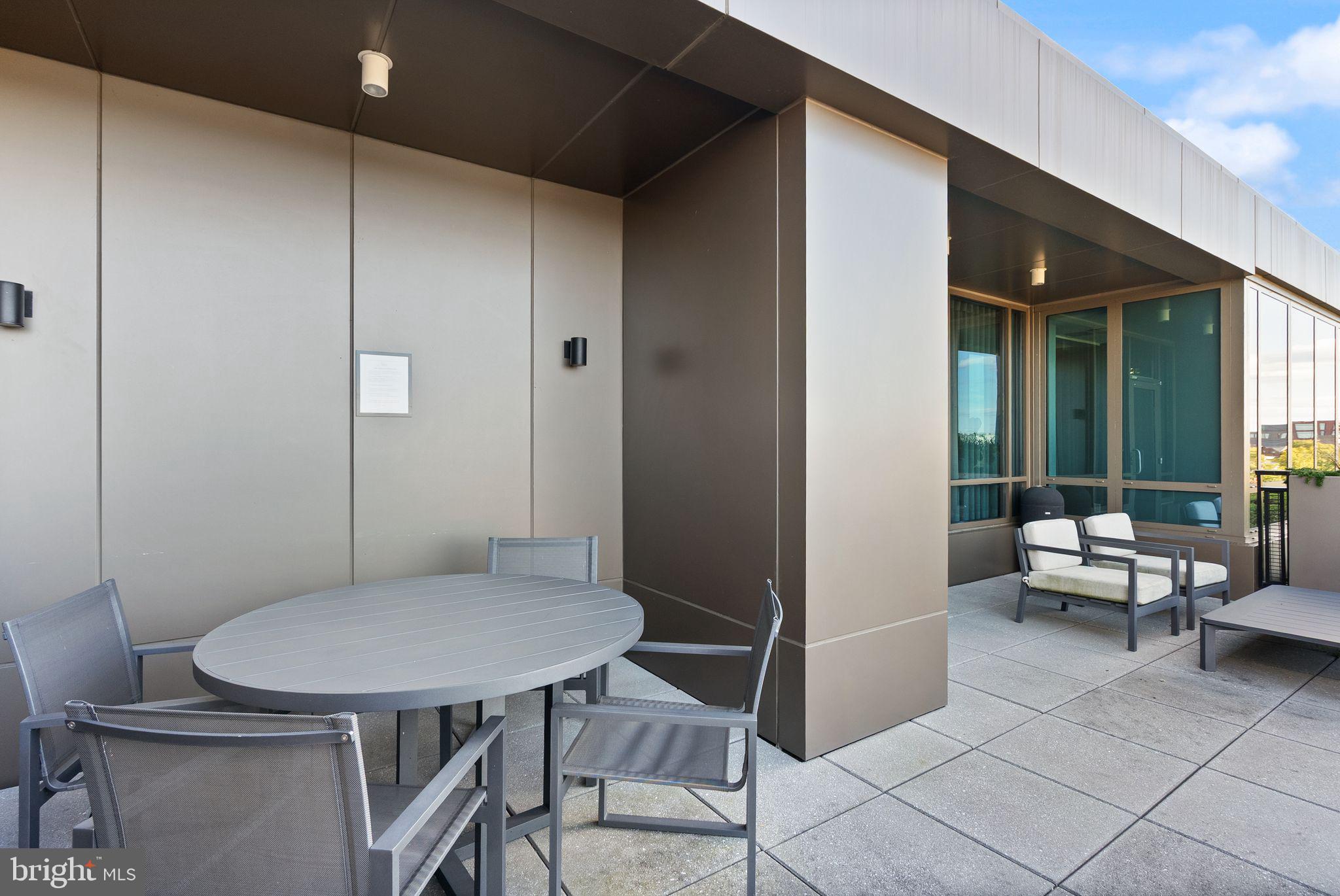 1111 Pennsylvania Ave. Southeast, Unit 304 Washington, DC 20003 - Photo 33 of 42 a view of a room that has a table and chairs in it