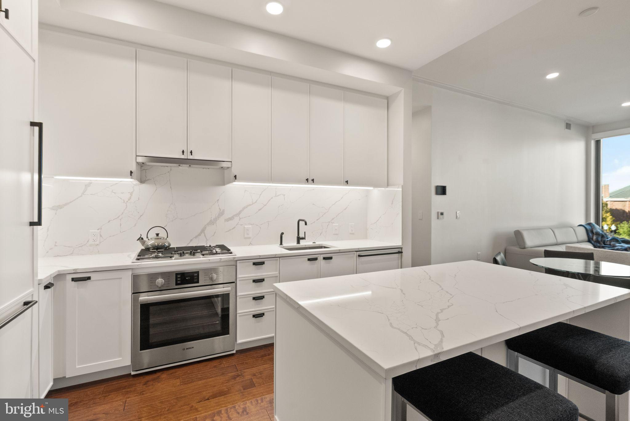 1111 Pennsylvania Ave. Southeast, Unit 304 Washington, DC 20003 - Photo 4 of 42 a kitchen with a stove a sink and a refrigerator