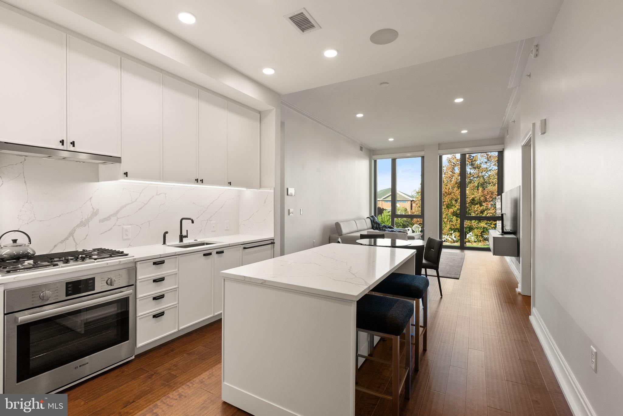 1111 Pennsylvania Ave. Southeast, Unit 304 Washington, DC 20003 - Photo 5 of 42 a large white kitchen with a large window