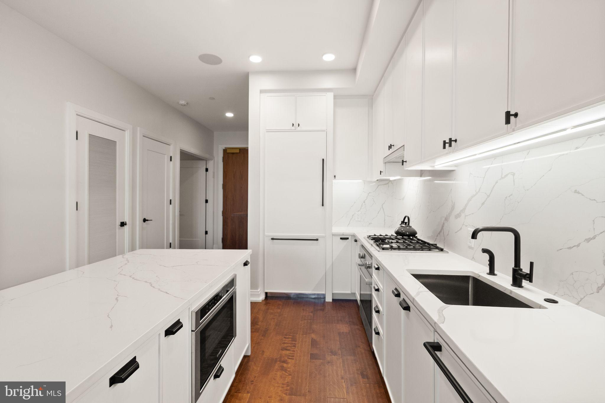 1111 Pennsylvania Ave. Southeast, Unit 304 Washington, DC 20003 - Photo 6 of 42 a kitchen with a sink a stove and refrigerator
