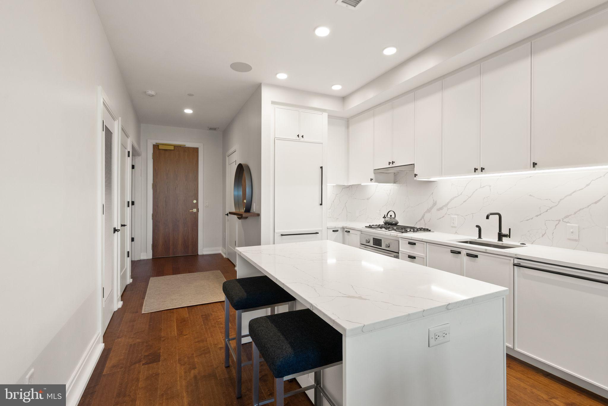1111 Pennsylvania Ave. Southeast, Unit 304 Washington, DC 20003 - Photo 7 of 42 a kitchen with stainless steel appliances a sink a stove a refrigerator and cabinets