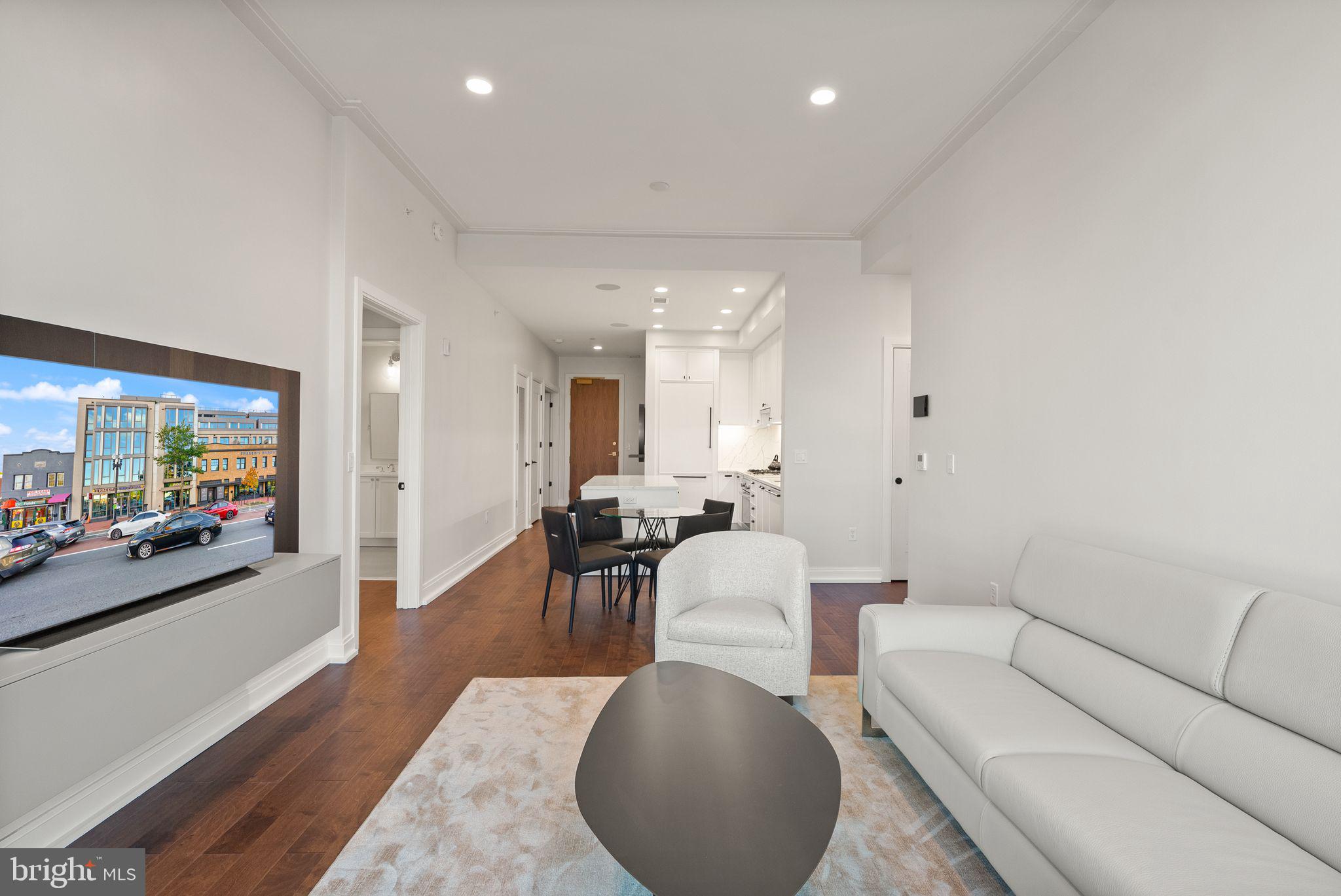 1111 Pennsylvania Ave. Southeast, Unit 304 Washington, DC 20003 - Photo 10 of 42 a living room with furniture and a flat screen tv