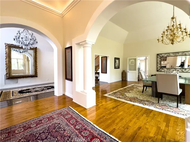 a living room with dining table and paintings on the wall
