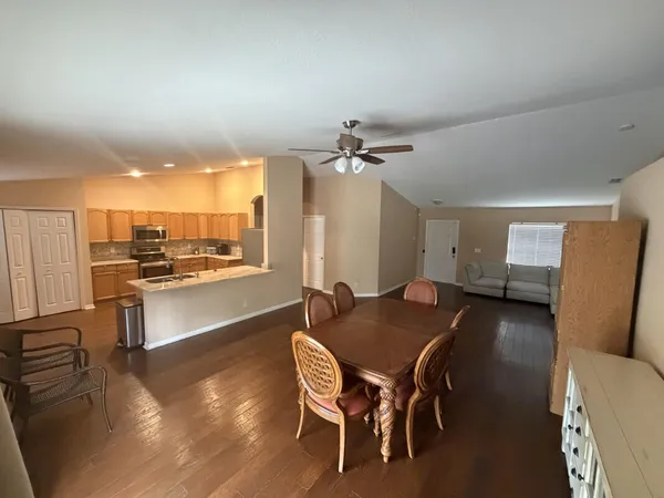 a dining room with furniture and wooden floor