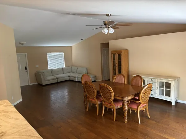 a view of a dining room with furniture and wooden floor