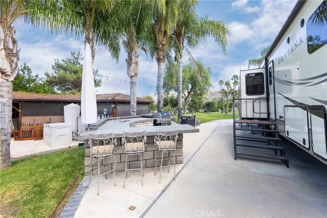 a view of a house with backyard and sitting area