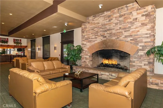 a living room with pool table and chairs