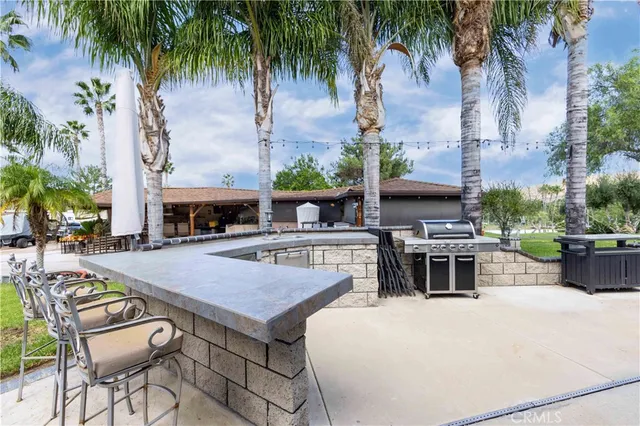 a view of house with swimming pool and patio