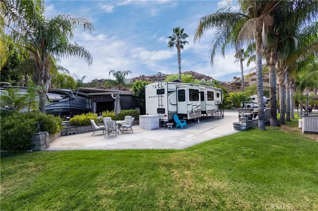 a view of a swimming pool with lawn chairs and a fire pit