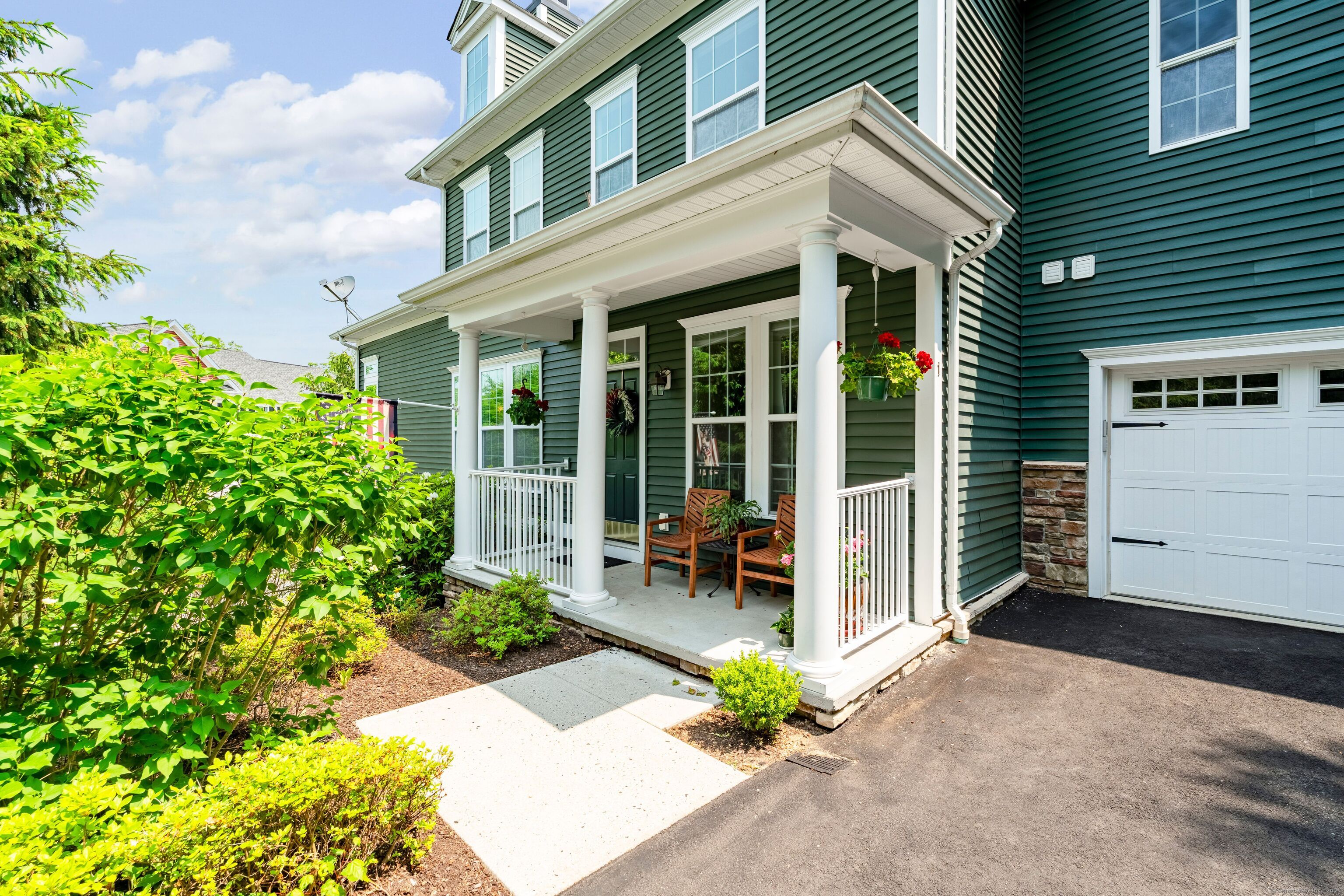 a front view of a house with a garden and plants