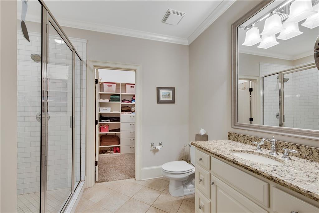 13942 Tree Loft Road Milton, GA 30004 - Photo 50 of 102 a bathroom with a granite countertop sink toilet and shower