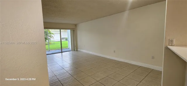 a view of an empty room with floor to ceiling windows