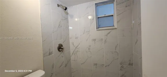 a bathroom with a shower and a toilet