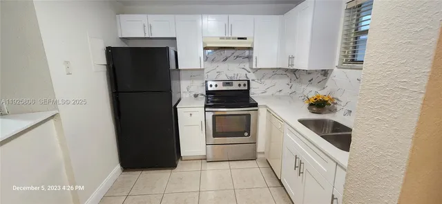 a kitchen with a refrigerator and a stove