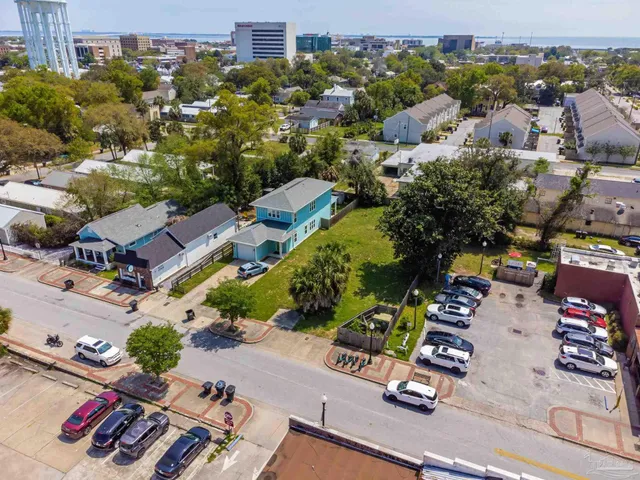 an aerial view of residential houses with outdoor space
