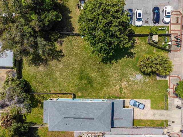 an aerial view of a house with a yard