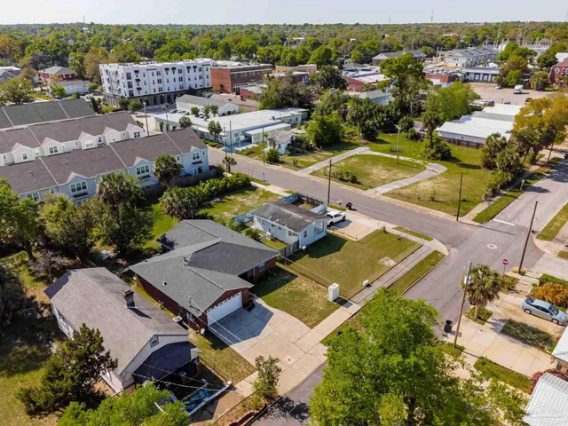 an aerial view of a house with a swimming pool yard and outdoor seating