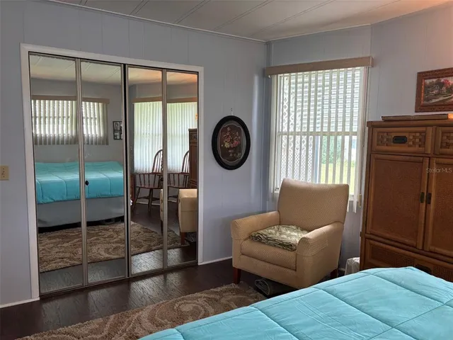 a living room with furniture a window and a clock