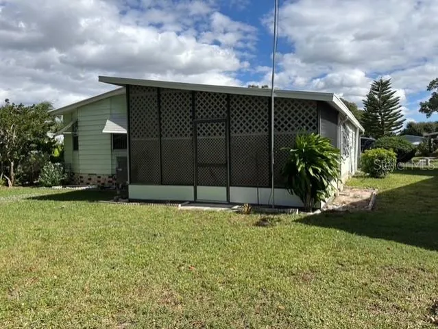 a view of backyard with potted plants and a bench
