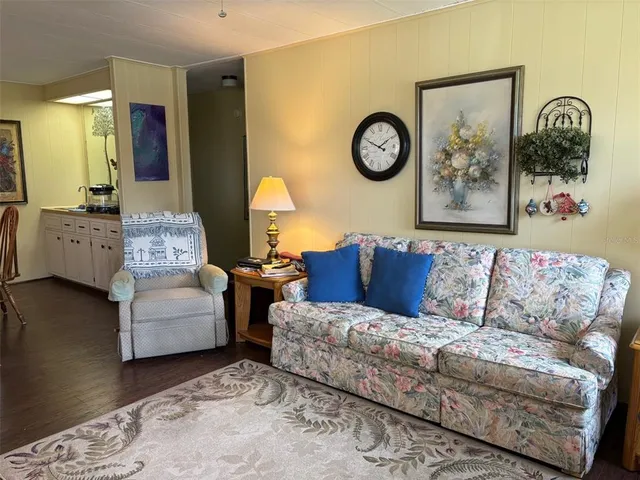 a living room with furniture and a mirror