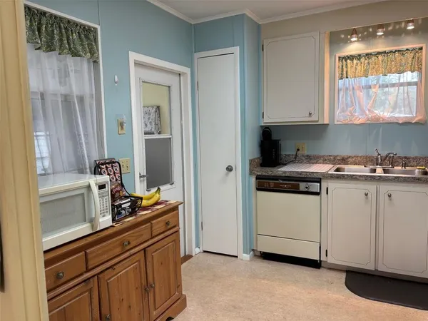 a kitchen with cabinets and window