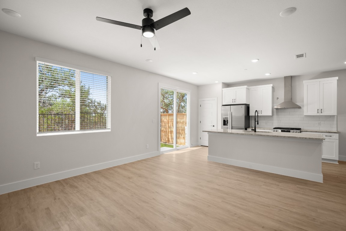 17407 Homestead Haven Drive Bee Cave, TX 78738 - Photo 5 of 16 a kitchen with stainless steel appliances a refrigerator sink and cabinets