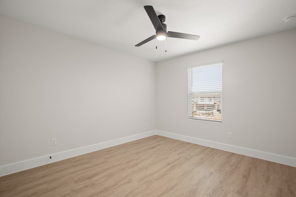 17407 Homestead Haven Drive Bee Cave, TX 78738 - Photo 7 of 16 an empty room with wooden floor and windows