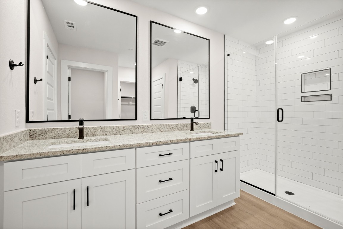 17407 Homestead Haven Drive Bee Cave, TX 78738 - Photo 8 of 16 a bathroom with double sink and a mirror