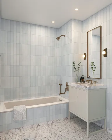 a bathroom with a double vanity sink toilet and shower