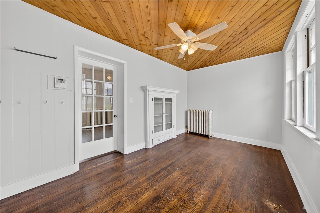 65 2nd Street Slatington, PA 18080 - Photo 24 of 46 This versatile room features warm wood plank ceilings, rich hardwood flooring, and a glass-paned door.