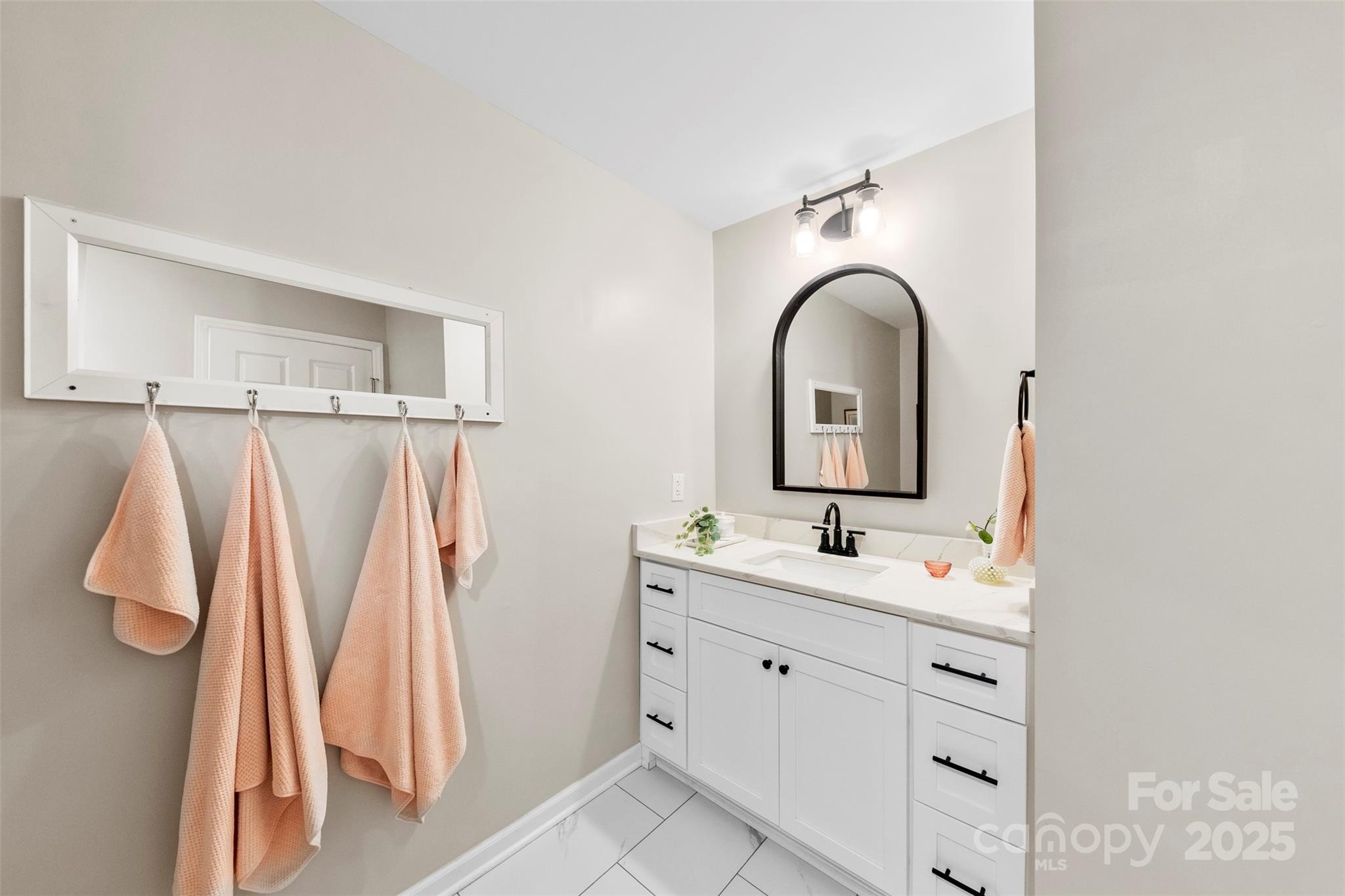 411 South Battleground Avenue Kings Mountain, NC 28086 - Photo 16 of 38 a bathroom with a sink and a mirror